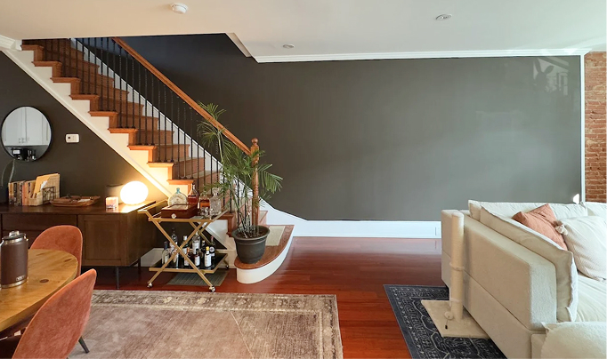 Image of a room with furnitures and beautiful staircase and wall after being painted