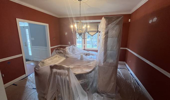 Furnitures covered and walls being painted.